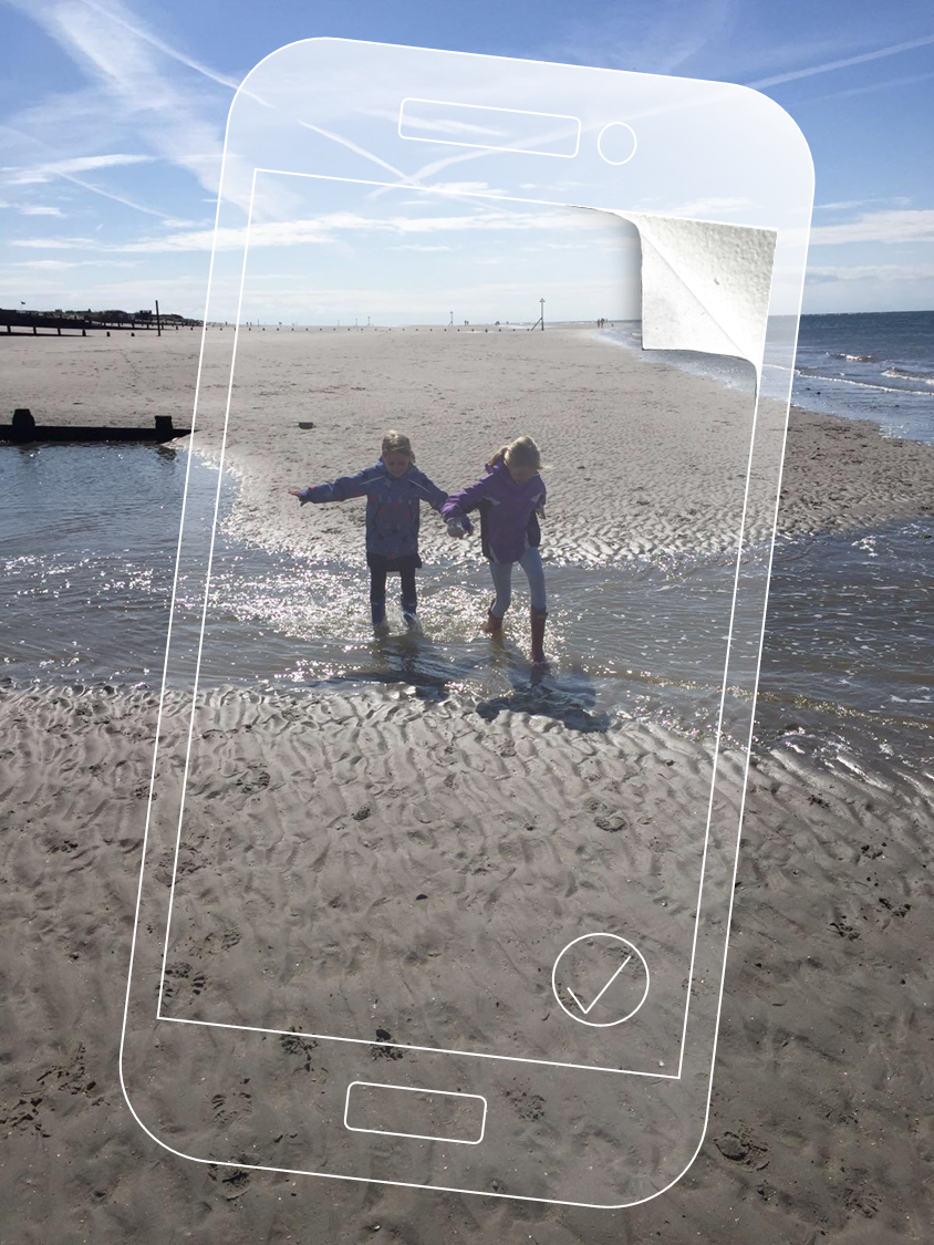 Two kids running across a sunny beach with phone overlay and peeling corner effect